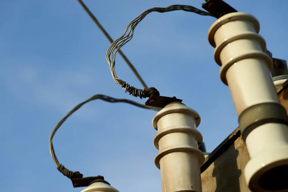 Aluminum wire screwed to an electrical transformer 